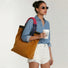 Model wearing the corduroy side of the tote on shoulder, showing sophisticated casual look