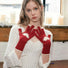 Model wearing sweetheart knitted gloves in red with heart motif; warm and cute for winter date nights.