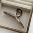 Folded view of one-word style of Tartan Elegance Hair Claw, ideal for quick updos and ponytails.