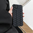 Model holding black Textured Woven Case. Intricate three-dimensional woven-style finish for a tactile feel.