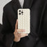 Model holding white Textured Woven Case. Elegant 3D woven pattern on a flexible, durable frame.