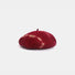Red and white tie-dye wool beret displayed on a white background.