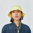 Model wearing cream yellow Ultralight Quick Dry Bucket Hat. Features lightweight tech nylon for rapid drying.