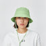 Model wearing fresh green Ultralight Quick Dry Bucket Hat, designed for peak performance and sun protection outdoors.