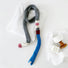 Close-up of Vibrant Colorblocked Skinny Scarf in gray and blue, easy for travel packing and gifting.