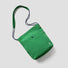 Front view of the vibrant forest green waterproof bag, highlighting the subtle sheen of the technical fabric.
