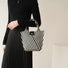 Model carrying a black Vintage Striped Knitted Handbag, great for daily carry and travel.