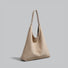 Frontal view of the minimalist khaki suede hobo bag with a clean silhouette.
