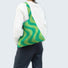 Model carrying a green Wave Pattern Knitted Bag on shoulder , easy for commuting and weekends.