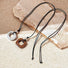 Front view of two pieces of Wild Grace Geometric Pendant Necklace in brown and grey.