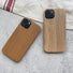 Two TPU cases with a natural wood grain finish, featuring one darker and one lighter tone.