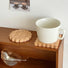 Close-up of 2 piecesof Wooden Biscuit Coaster in round and square shapes..