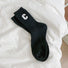 Angled view of Wool C Socks in black, great for daily wear and lounging.