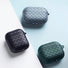 Three woven silicone AirPods case covers in gray, black, and dark green, showcasing the textured design.