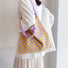 Back view of a model carrying the yellow and purple checkered bag for a relaxed look.