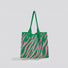 Angled view of green and pink zebra print knitted tote bag made from blended yarn, easy for commuting and weekends.