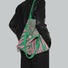 Model carrying a Zebra Print Knitted Tote Bag in green pink, great for daily carry and travel.