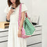 Model carrying a striped tote bag as crossbody, easy for commuting and weekends.