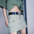 Model styling the black belt with siver butterfly buckle for a chic outfit.