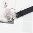 Close-up of the sleek belt with silver metal butterfly buckle.