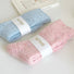 Close-up of the thermal knit texture on the pink and blue candy wool socks.
