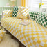 Green and yellow Checkerboard Pillow Covers on a couch with yellow checkered blanket, ideal for home decor.