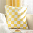 Folded view of Checkerboard Pillow Cover in yellow, easy for parties and everyday use.