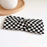 Flat lay of Checkered Twist Headband in black, great for everyday styling and gifting.