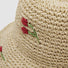 Close-up of the high-quality straw material and cherry embroidery detail.