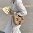 Model carrying a khaki Cherry Rattan Straw Bag handheld, easy for commuting and weekends.