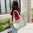 Model wearing the beige Cloud Puff Tote Bag on her shoulder.