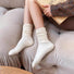 White cotton slouch socks on legs, featuring a relaxed, ruched design.