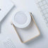 White and wood Creative Lantern Lamp, retracted as a searchlight, with a light wood handle.