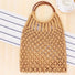 Angled view of camel cotton crochet handbag with round wooden ring handles, featuring an open-weave macrame design.