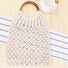Flat lay of Crochet Handbag With Wooden Ring in white, great for everyday carry and travel.