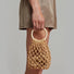 Model carrying a Crochet Mini Handbag With Wooden Ring handheld , great for daily carry and travel.