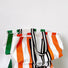 Two designer canvas tote bag are displaying on the table, and the orange tote is in front.