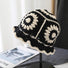 Front view of black Floral Crochet Hat. Versatile dark tone with detailed handcrafted crochet textures.
