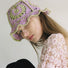 Model wearing purple Floral Crochet Hat, featuring intricate handmade floral patterns and a soft fit.