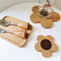 Angled view of two Flower Cork Coaster/Hot Pads on a white table, with a cup on one coster.