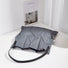 Gray canvas foldable pleated shopper bag with black strap.