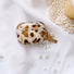 Close-up of Leopard Print AirPods Case Cover with shell charm, easy to carry for commutes and errands.