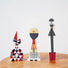 Set of three abstract wooden figurines with geometric patterns on a wooden surface.