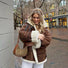 Model carrying a brown Monogram Crescent Bag in hand, easy for commuting and weekends.