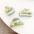 Three acrylic oil painting hair claws in varying sizes, featuring a green and white marbled design.