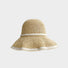 Close-up of light beige sun hat highlighting delicate woven straw pattern for tropical summer styling.