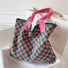 Large pink and green checkered knitted tote bag featuring a soft, thick woven texture.