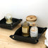 Close-up of two black PU Leather Tray with bottles , ideal for tidy shelves and daily use.