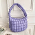 Purple puffy shoulder bag on a white background.
