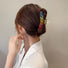 Model wearing a Rainbow hair claw, great for everyday styling and gifting.